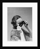 1930s 1940s woman putting on taking off black eye mask by Anonymous