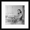 1960s satisfied woman homemaker holding folded laundry by Anonymous