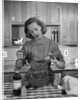 1960s woman baking in kitchen by Anonymous