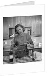 1960s woman baking in kitchen by Anonymous