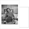 1960s woman baking in kitchen by Anonymous