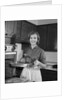 1960s smiling woman in kitchen taking roast out of oven looking at camera by Anonymous