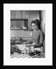 1960s woman housewife baking biscuits in kitchen by Anonymous