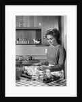 1960s woman housewife baking biscuits in kitchen by Anonymous