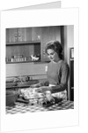 1960s woman housewife baking biscuits in kitchen by Anonymous