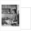 1960s woman housewife baking biscuits in kitchen by Anonymous