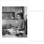 1960s woman housewife baking biscuits in kitchen by Anonymous
