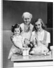 1940s 1950s mother daughter grandmother stuffing turkey by Anonymous