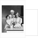 1940s 1950s mother daughter grandmother stuffing turkey by Anonymous