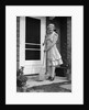 1940s smiling woman sweeping porch front door step with a broom looking at camera by Anonymous