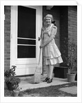 1940s smiling woman sweeping porch front door step with a broom looking at camera by Anonymous