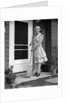 1940s smiling woman sweeping porch front door step with a broom looking at camera by Anonymous