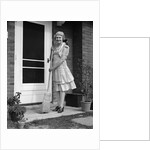 1940s smiling woman sweeping porch front door step with a broom looking at camera by Anonymous