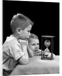 1940s two boys waiting watching sand falling in hourglass by Anonymous