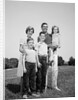 1960s smiling family portrait standing on grass mother father three children by Anonymous