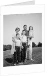 1960s smiling family portrait standing on grass mother father three children by Anonymous