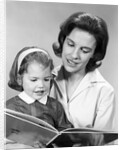 1960s woman reading story book to girl child by Anonymous