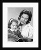 1960s woman reading story book to girl child by Anonymous
