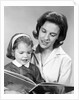 1960s woman reading story book to girl child by Anonymous