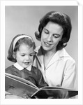 1960s woman reading story book to girl child by Anonymous