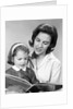 1960s woman reading story book to girl child by Anonymous