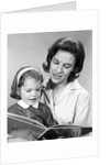 1960s woman reading story book to girl child by Anonymous