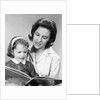 1960s woman reading story book to girl child by Anonymous