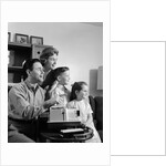 1960s happy family looking at slides on slide projector by Anonymous
