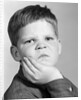 1960s little boy making angry funny facial expression looking at camera by Anonymous
