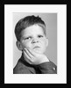 1960s little boy making angry funny facial expression looking at camera by Anonymous