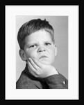1960s little boy making angry funny facial expression looking at camera by Anonymous