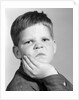 1960s little boy making angry funny facial expression looking at camera by Anonymous