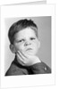 1960s little boy making angry funny facial expression looking at camera by Anonymous