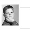 1960s little boy making angry funny facial expression looking at camera by Anonymous