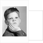 1960s little boy making angry funny facial expression looking at camera by Anonymous