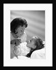 1960s daughter with mother tucking into bed by Anonymous