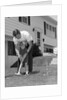 1960s father and young daughter playing croquet in yard by Anonymous