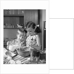 1960s two children boy girl bowl mixing pouring milk in kitchen by Anonymous