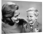 1960s portrait mother with arm around son dressed in school uniform with bow tie & emblem crest on jacket mom pearl lace collar by Anonymous