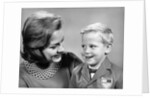 1960s portrait mother with arm around son dressed in school uniform with bow tie & emblem crest on jacket mom pearl lace collar by Anonymous