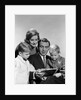 1960s family father mother sons reading book together by Anonymous