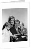 1960s family father mother sons reading book together by Anonymous
