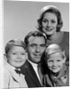 1960s family portrait father mother two sons smiling by Anonymous