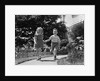 1950s two children holding hands smiling walking along sidewalk by Anonymous