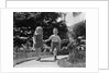 1950s two children holding hands smiling walking along sidewalk by Anonymous