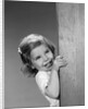 1960s child little girl smiling peeking around corner by Anonymous
