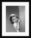1960s child little girl smiling peeking around corner by Anonymous