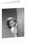 1960s child little girl smiling peeking around corner by Anonymous