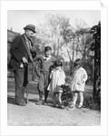1920s group of three children watching organ grinder's monkey in costume standing on hind legs by Anonymous