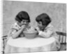 1930s two girls playing blowing soap bubble pipes by Anonymous